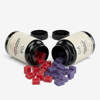 Cordyceps and Reishi bottles with orange and purple gummies spilled out